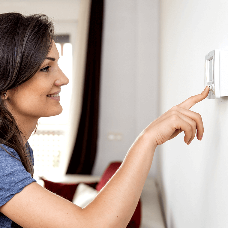 Woman touching thermostat